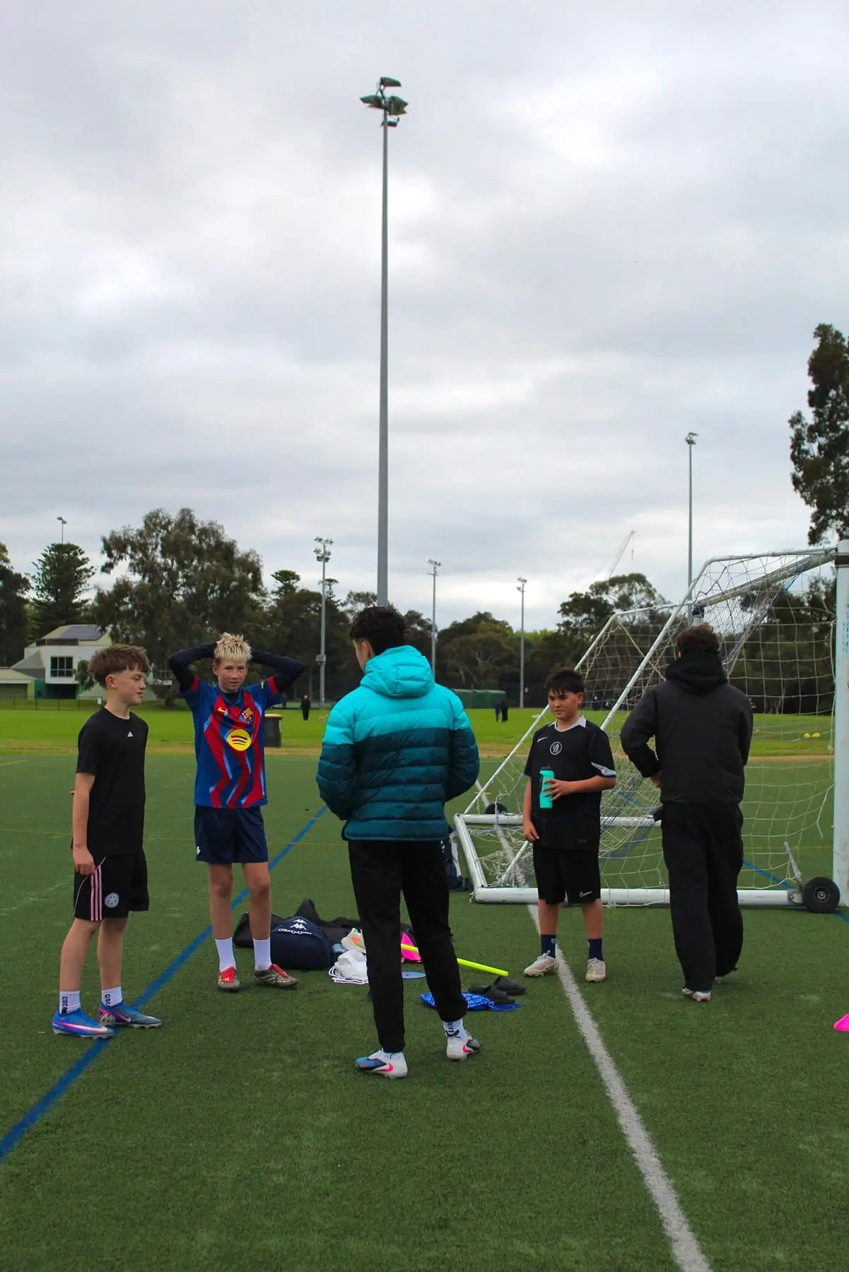 Coaches talking with players before a drill