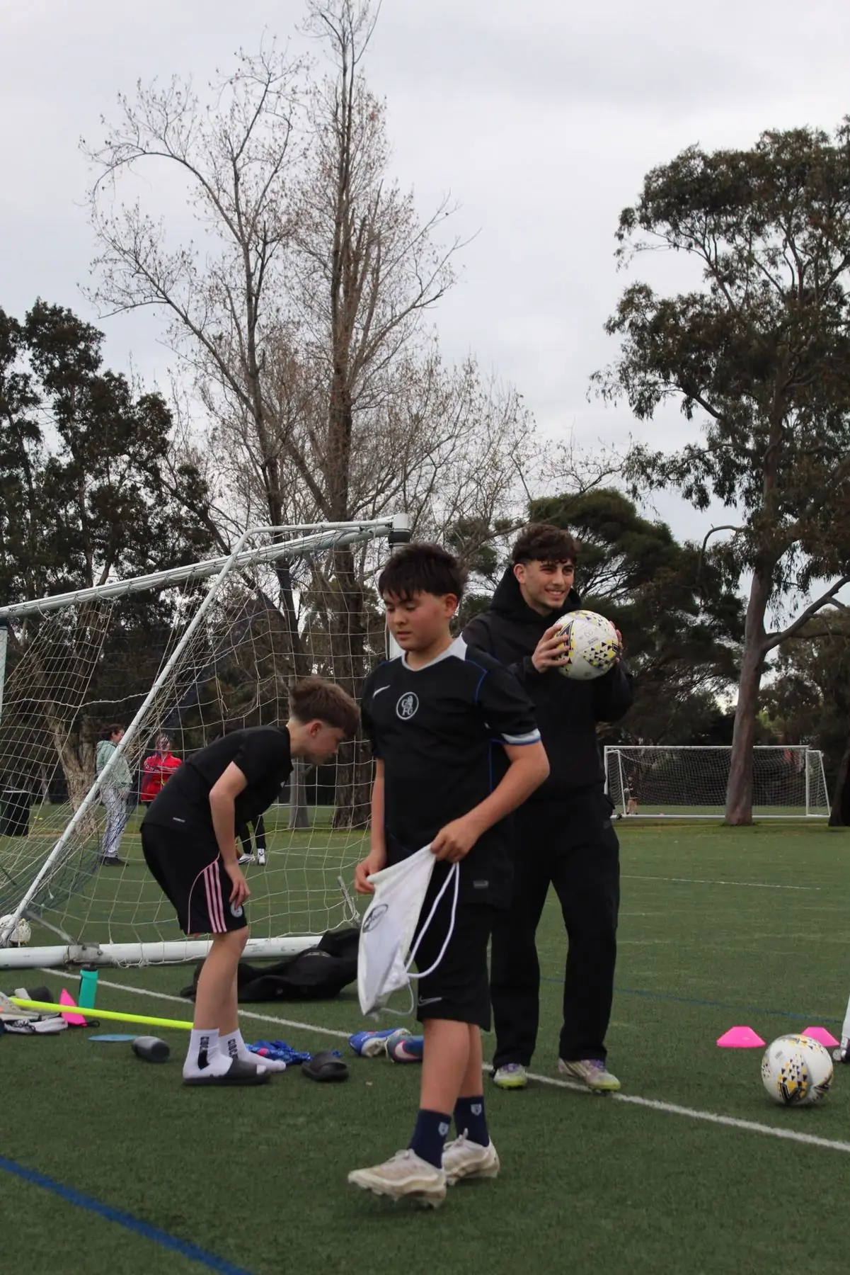 Players gathering after a session with Coach Josh